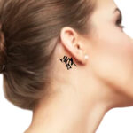 Small word tattoo behind the ear for female